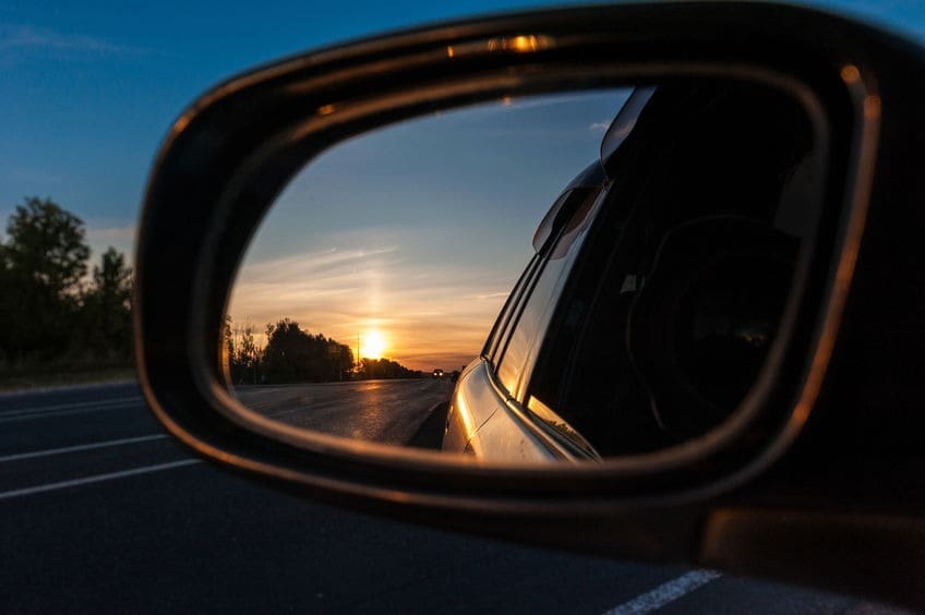 beautiful sunset in the mirror of the car